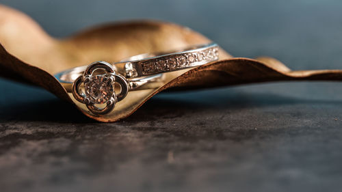Close-up of hand holding ring on table