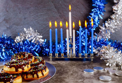 Close-up of illuminated candles on table