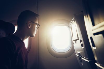 Man looking through airplane window