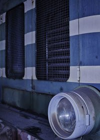 Close-up of metallic building against blue wall