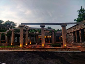 Low angle view of illuminated bridge against sky at dusk
