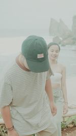 Rear view of woman standing at beach