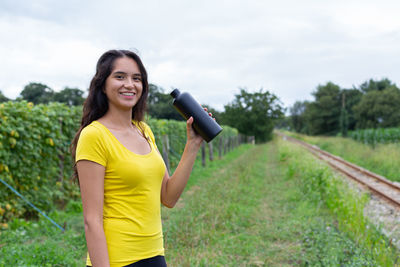 Young woman standing on field