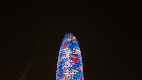 Low angle view of multi colored lights against sky at night
