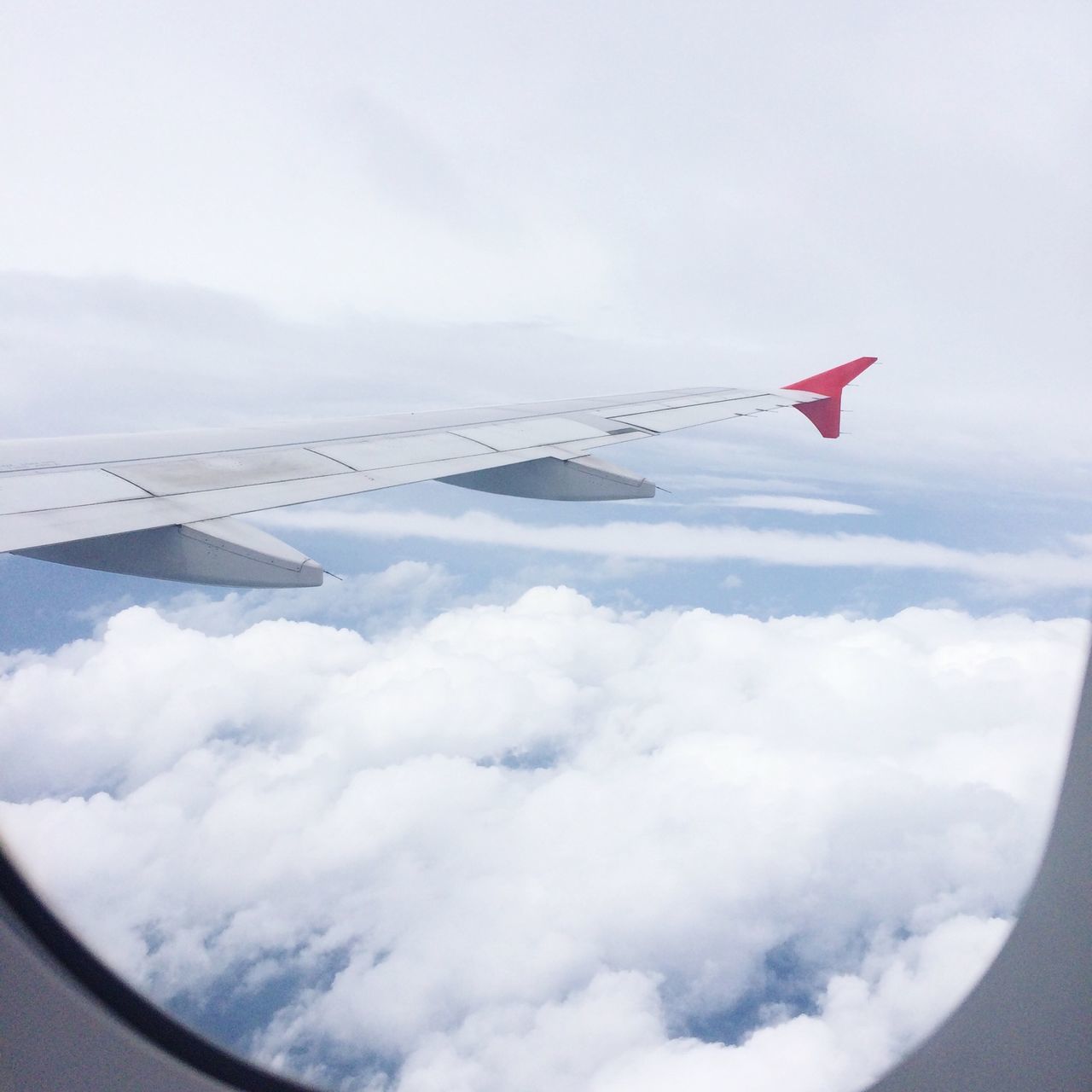 flying, airplane, air vehicle, transportation, aircraft wing, mode of transport, sky, mid-air, part of, cloud - sky, cropped, travel, journey, on the move, cloudscape, cloud, aerial view, scenics, nature, beauty in nature