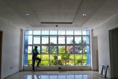 Man standing by window