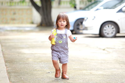 Portrait of cute girl standing outdoors