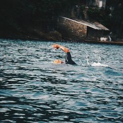 Full length of woman jumping in water