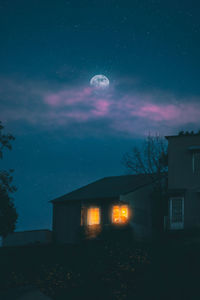 Illuminated building against sky at night