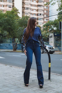 Full length of woman on street in city