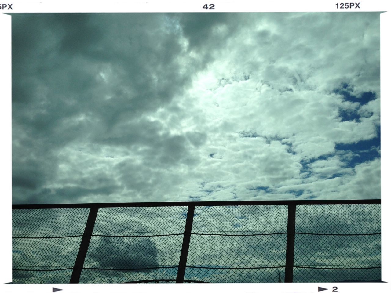 sky, cloud - sky, transfer print, cloudy, auto post production filter, weather, overcast, low angle view, cloud, fence, built structure, storm cloud, day, architecture, outdoors, nature, building exterior, no people, protection, cloudscape