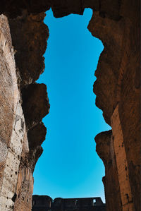 Low angle view of rock formation against clear sky