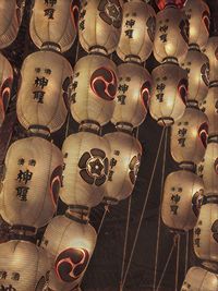 Low angle view of illuminated lanterns hanging on ceiling