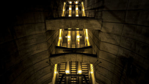 Illuminated subway escalator in the underground