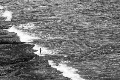 High angle view of man standing in sea