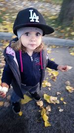 Portrait of cute boy with hat on road