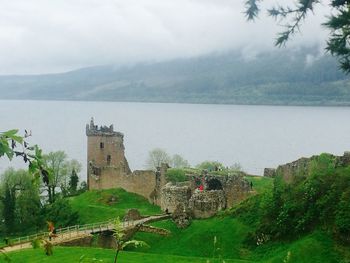 Scenic view of grassy field against sky