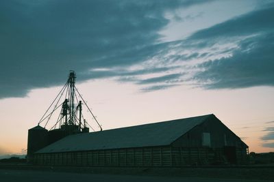 Old mill against sky at dusk