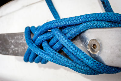 Close-up of blue rope tied to boat