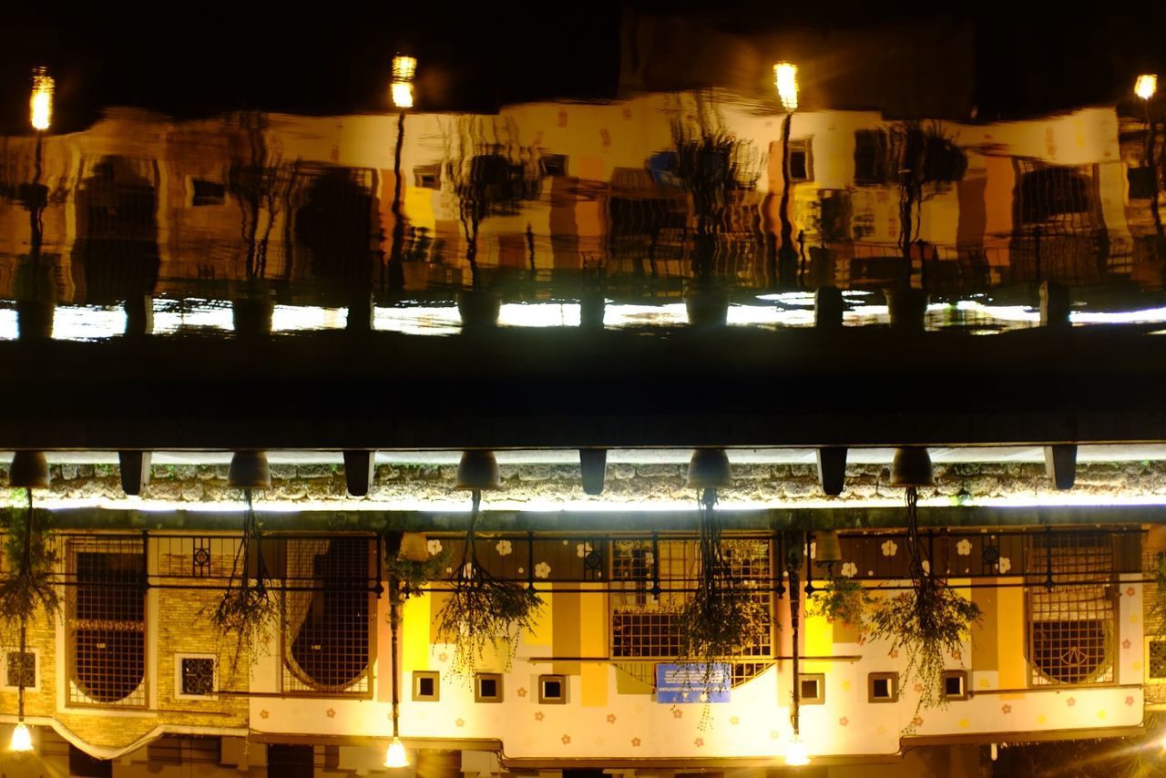 REFLECTION OF ILLUMINATED BUILDINGS ON GLASS