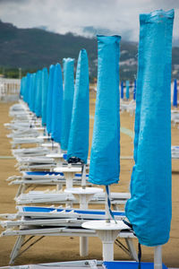 Blue chairs with umbrellas on beach