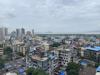 High angle view of buildings in city against sky