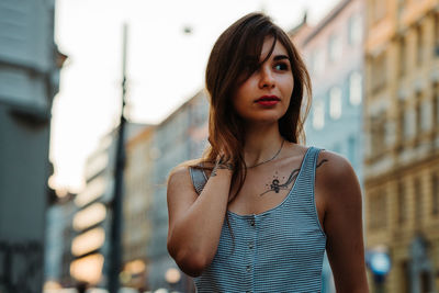 Portrait of young woman standing outdoors