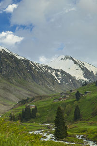 Scenic view of mountains against cloudy sky