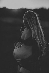 Pregnant woman standing against blurred background