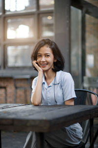 Young woman sitting on bench
