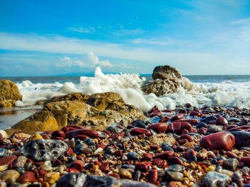 Rocks on beach against sky