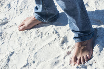 Low section of man legs on sand