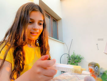 Portrait of a smiling girl holding indoors