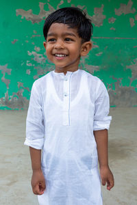 Portrait of smiling boy standing outdoors