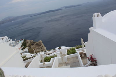 High angle view of buildings by sea against sky