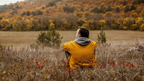 Rear view of woman standing on field