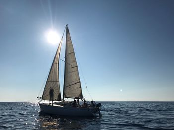 Sailboat sailing on sea against clear sky