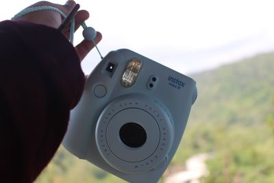 Close-up of photographer holding camera