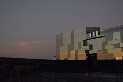 Buildings against dramatic sky during sunset