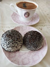 Close-up of coffee on table with 2 chocolate cake