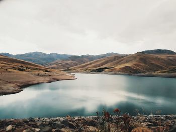 Scenic view of lake and mountains against sky