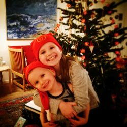 Portrait of smiling boy with christmas tree at home