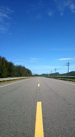Surface level of road against blue sky