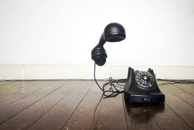 Telephone booth on table against wall at home