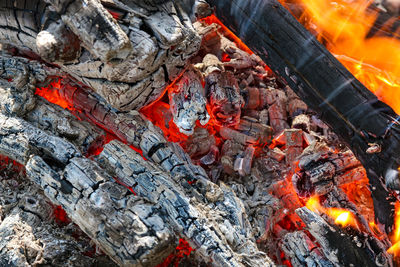 Burning firewood and coals of a fire close up. close-up of bonfire