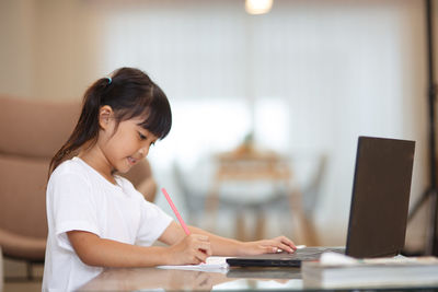 Cute girl studying at home