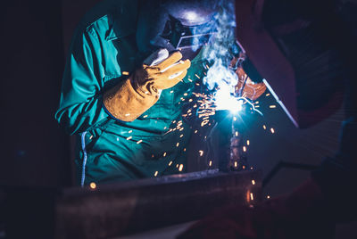 Close-up of man working on metal