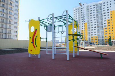 Information sign on street against buildings in city