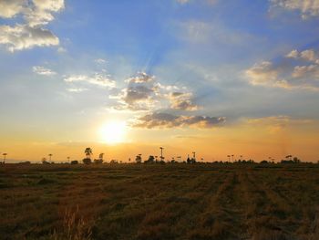 Scenic view of field against sky during sunset