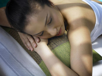 High angle view of woman relaxing on lounge chair